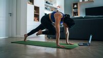 Woman practicing yoga at home