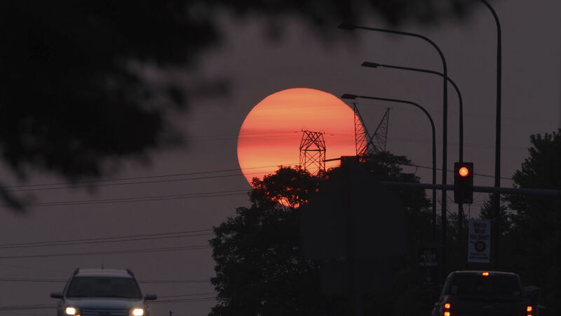Stunning sunsets and hazy skies seen thousands of miles away from US wildfires