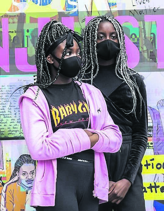 Daniella Egwin and Esther Airbasoye, two of the young artists involved in creating a Black Lives Matter artwork at the Nano Nagle Place entrance plaza on Douglas St, Cork. The artwork was unveiled by the Cork Migrant Centre and Cork Printmakers.