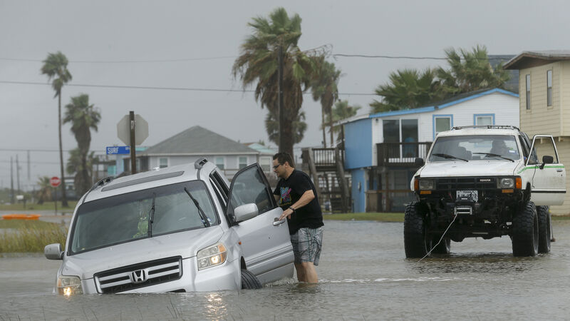 Tropical storm stalls along Texas coast, flooding city streets