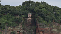 Floodwater touches toes of famous Buddhist statue as China hit by typhoon