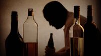 Alcohol bottles with the Silhouette of an alcoholic man