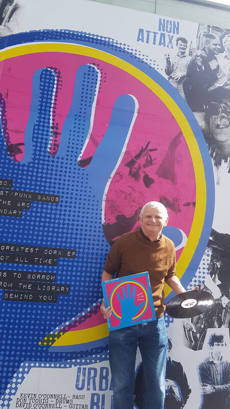Pictured at the new artwork outside the City Library is Ricky Dineen of Nun Attax with one of the original Kaught at the Kampus records from 1980. Pic: Siobhan Bardsley