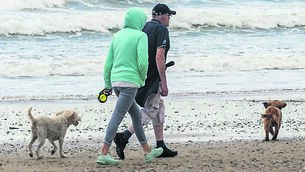 <p class="contextmenu internal_Caption">People on the beach at Garretstown, West Cork — it hasn’t been a great summer in Ireland this year</p>