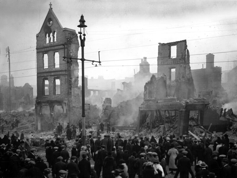Crowds of onlookers throng Patrick Street on the day following the burning of Cork city centre by Crown Forces in 1920.
