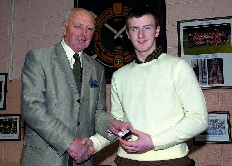 Denis Coughlan presenting Patrick Horgan, captain of the 2006 County Minor Championship winning team, with his county medal.