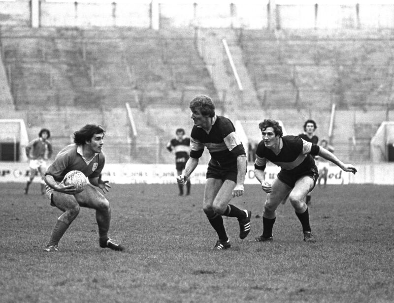 Richie Bell about to tackled by Denis Long when Austin Stacks faced Thomond College.