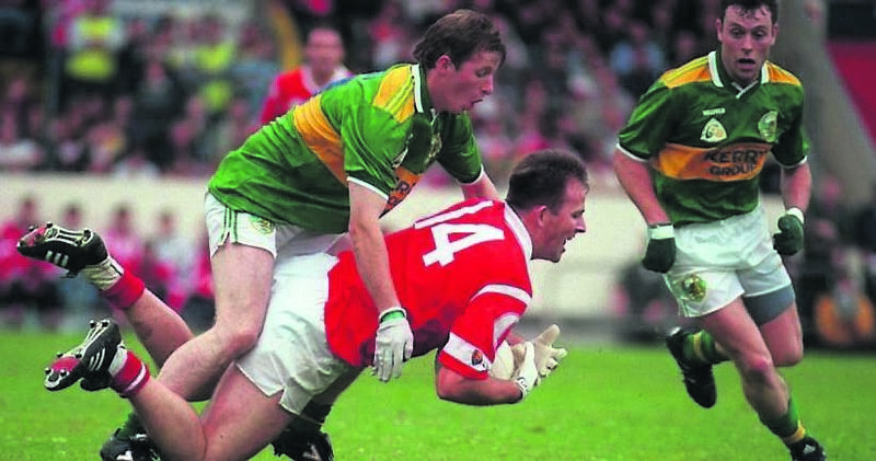 Cork’s Colin Corkery goes down under the challenge of Kerry’s Bingo Driscoll.