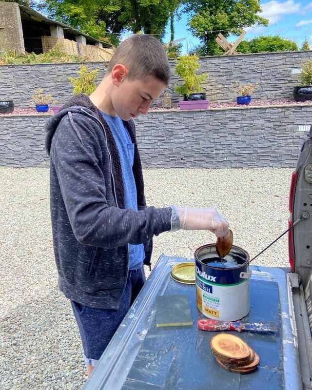 Conor McLoughlin varnishing the coasters. Conor McLoughlin varnishing the coasters.