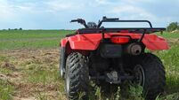 Newly planted grain crop and farmer's Quad