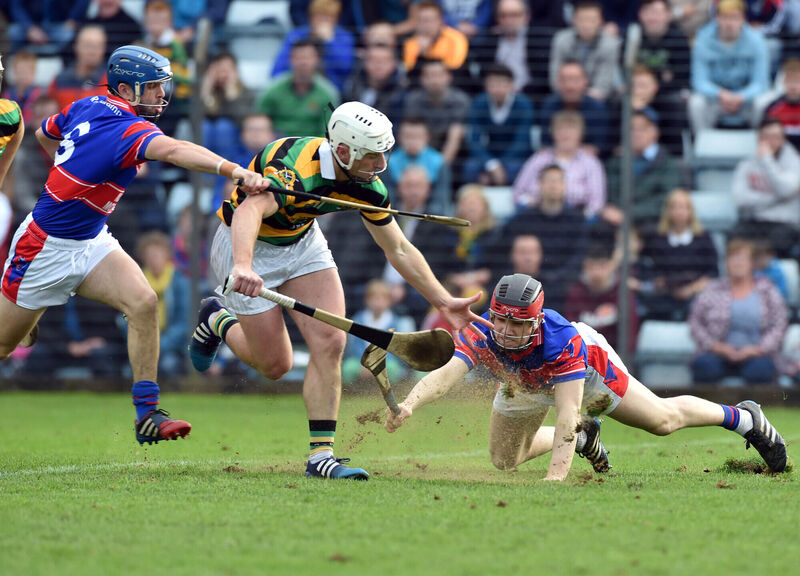 Horgan is tackled by Erins Own's Shane Murphy and Jack Sheehan. Picture: Eddie O'Hare