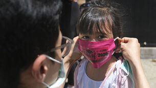 A preschooler wears a mask at Bradford School in Jersey City. (AP Photo/Seth Wenig)