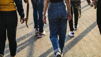 Rear view of group of school friends walking outdoors lifestyle