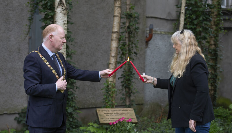 The Lord Mayor of Cork , Cllr. John Sheehan lighting a candle with Fiona Corcoran, founder of the  Chernobyl Greater Cause at the short remembrance ceremony to mark  the 34th anniversary of The Chernobyl Disaster at Bishop Lucey Park, Cork. Picture Dan LInehan