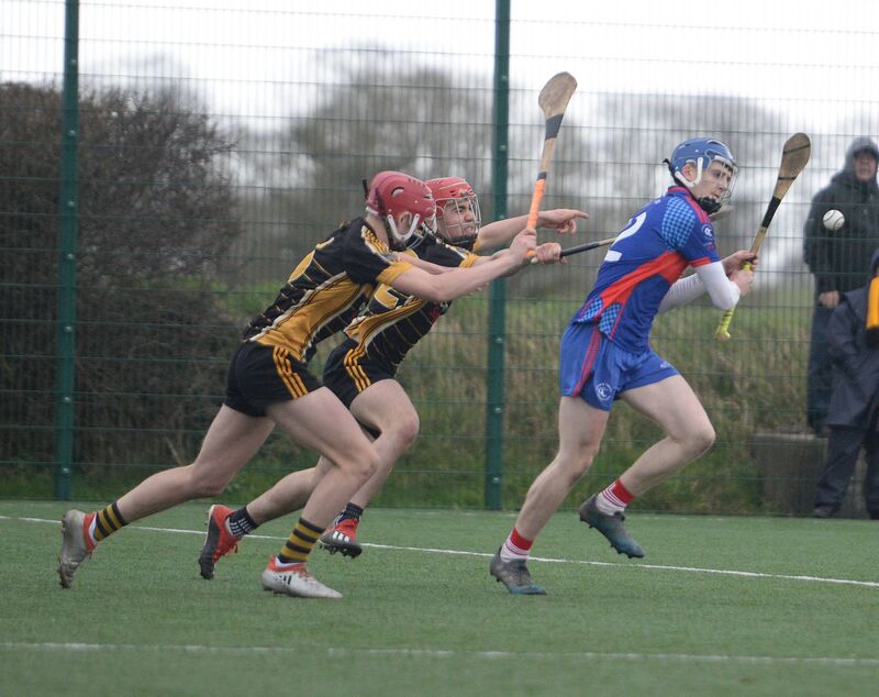 Brandon Murphy, Coláiste Treasa, shakes off the challenge of Holy Rosary College defenders in the All-Ireland Colleges C hurling semi-final at Rathkeale. Picture: John Tarrant