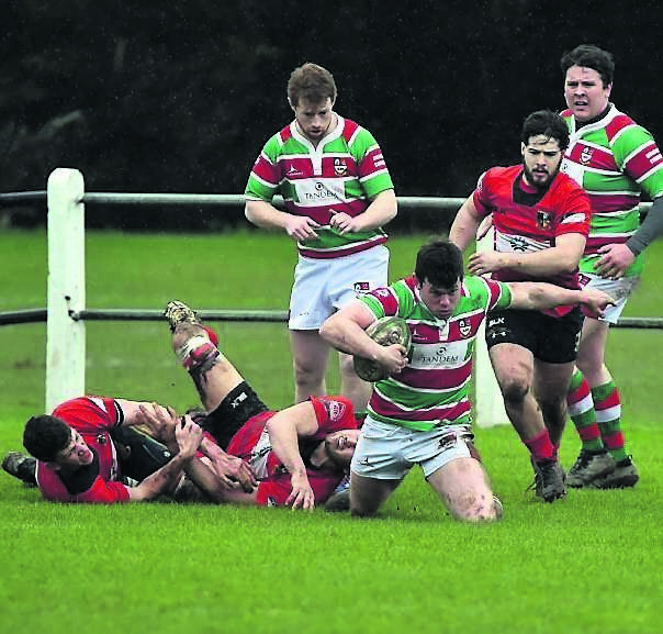 Sunday’s Well full-back Brian Derham on his knees as he breaks from Midleton’s Denis Broderick, Allan Ross and Rory Horgan. Sunday’s Well full-back Brian Derham on his knees as he breaks from Midleton’s Denis Broderick, Allan Ross and Rory Horgan.