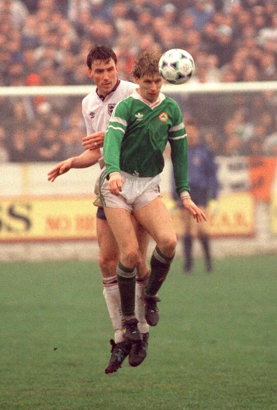 David Kelly heads the ball away from Andy Linighan.