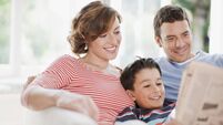 Family reading newspaper together