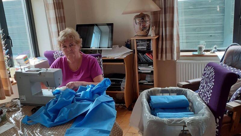 Betty Brosnan at her home in Carrigaline sewing on the extra material to the medical gowns.