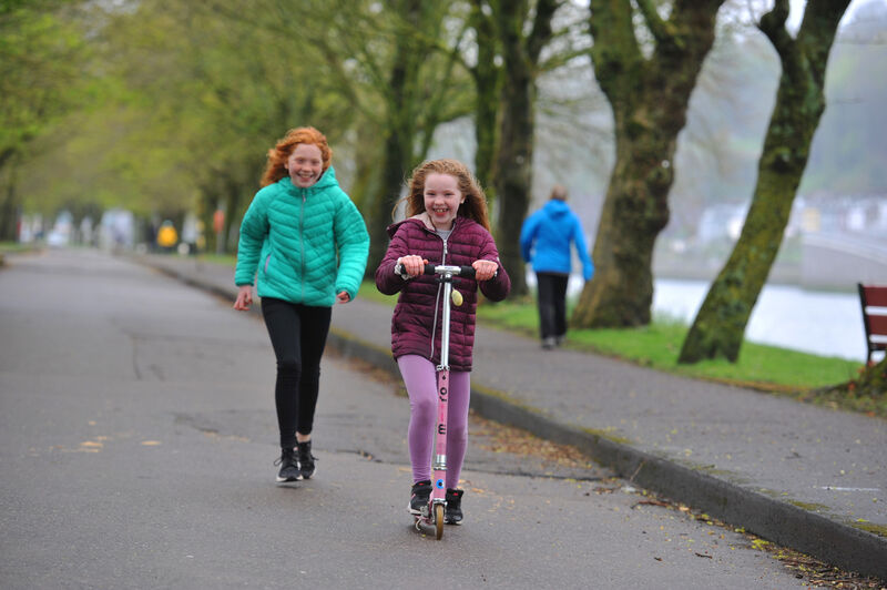 Sisters Niamh and Kate O'Brien get some exercise together, beside the River Lee, at The Marina, Cork on Saturday 18th April 2020. Picture: Larry Cummins