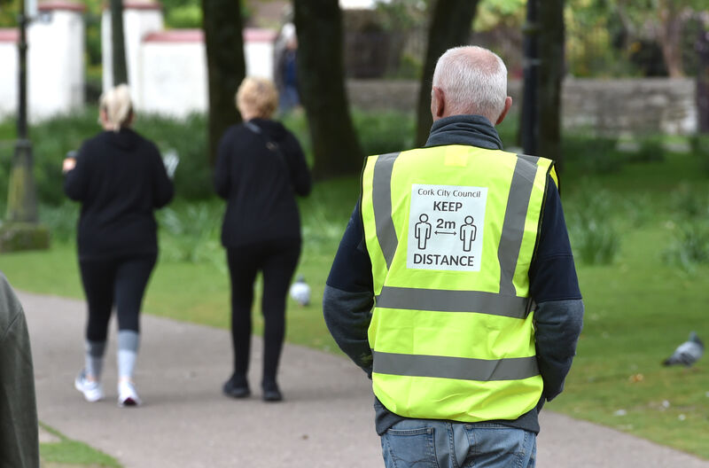 A Cork City Council park warden keeping an eye on social distance at the Lough, Cork. Picture: Dan Linehan