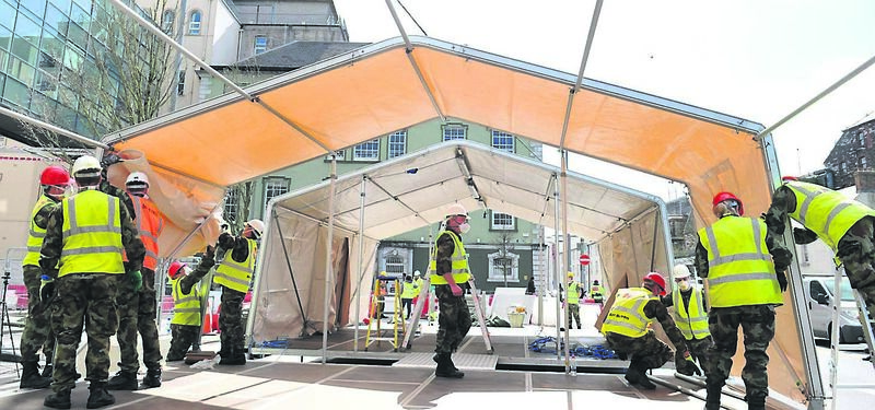 Defence Force personnel from 1 Brigade and The Irish Naval Service work together erecting Multi-Purpose Tactical Soft Shelters (MPTSS's) outside the Mercy University Hospital at Grenville Place, Cork City in support of the HSE's Covid-19 treatment strategy at the city centre hospital.