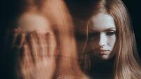 Stressed woman covering face