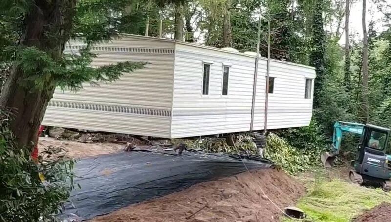 The mobile home being lifted into place. The mobile home being lifted into place.