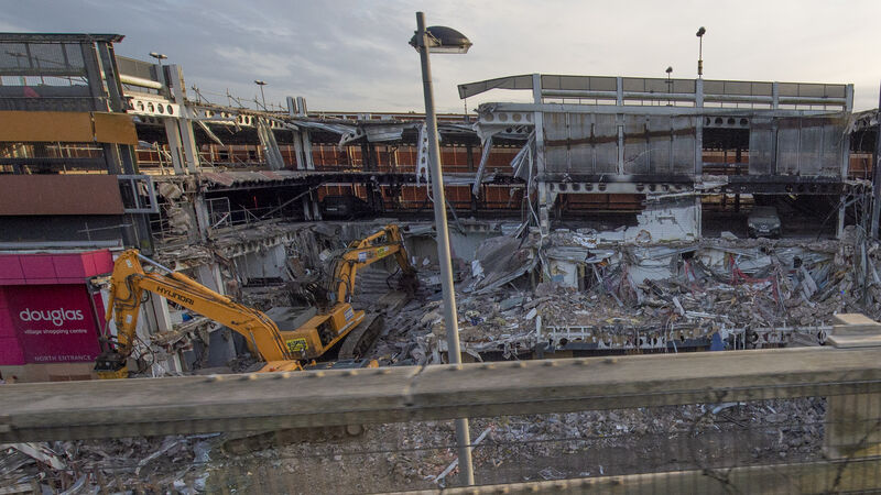A screen is needed to hide the Douglas Shopping Centre demolition to prevent 'rubber-necking' by motorists