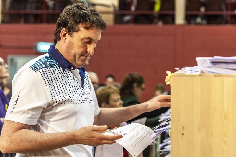 A member of the count staff checks a ballot paper at the Cork South West count centre.