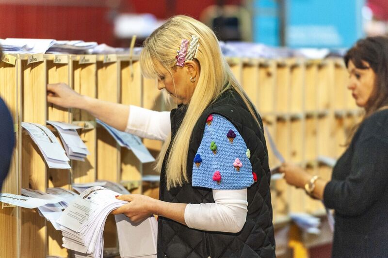  A member of the count staff checks a ballot paper at the Cork South West count centre. Picture: Andy Gibson.