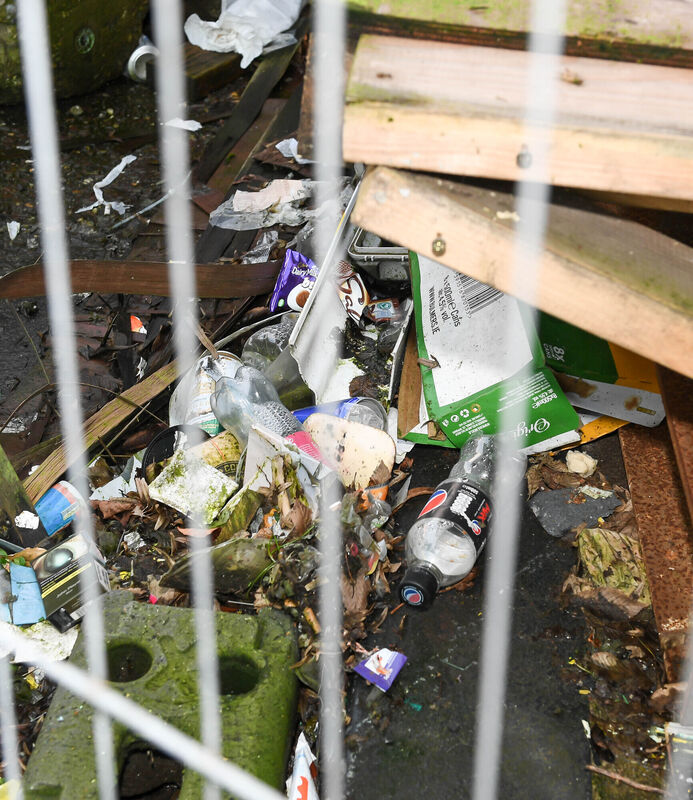 Some of the litter dumped inside the hoarding near the derelict buildings on North Main Street.Picture: David Keane.