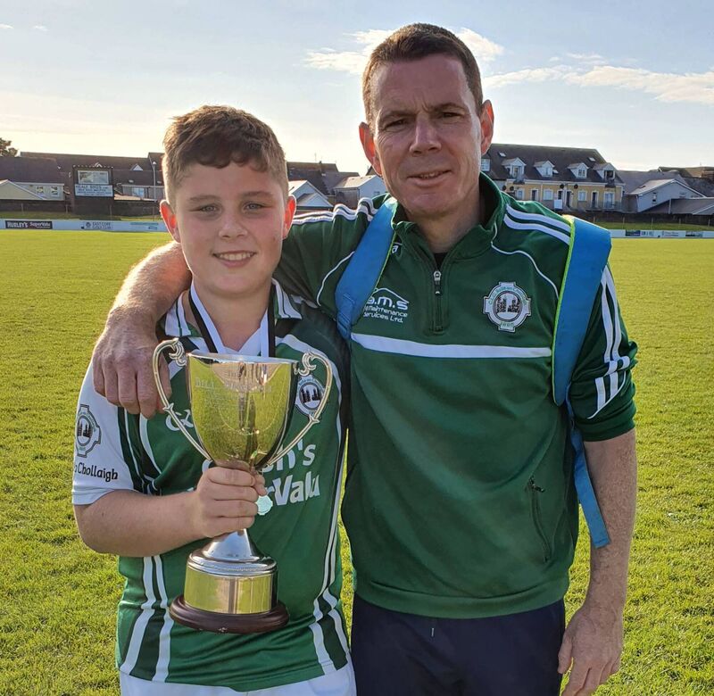 Ballincollig U13 manager Kevin Kirstein and his son Daniel with the Bill O'Keeffe Memorial Cup.