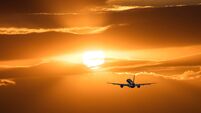 Plane is taking off at sunset