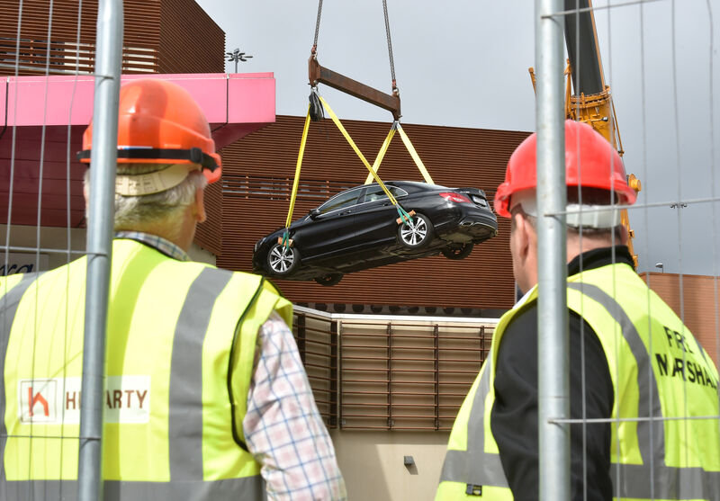 One of the first cars is hoisted from the car park on the roof of Douglas Village Shopping Centre, Douglas, Cork which was damaged by a large fire last weekend. Picture Dan Linehan One of the first cars is hoisted from the car park on the roof of Douglas Village Shopping Centre, Douglas, Cork which was damaged by a large fire last weekend. Picture Dan Linehan