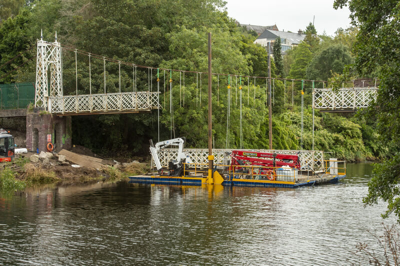 The first section of Daly’s Bridge known locally as the Shakey Bridge is placed on a barge to be taken away for restoration work which will take up to eight months. Picture Dan Linehan