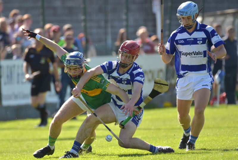 David Morrison, Castlelyons, is held back by Jack O’Sullivan and watched by Ciaran Lombard, Inniscarra. Picture: Dan Linehan
