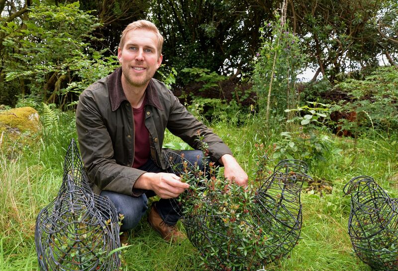 Adam Carveth, co-founder of Two Green Shoots and co-creator of the Garden of Re-Imagination near Glengarriff, Co. Cork, pictured with Chilean guava (in a hen shape). Picture Denis Minihane.