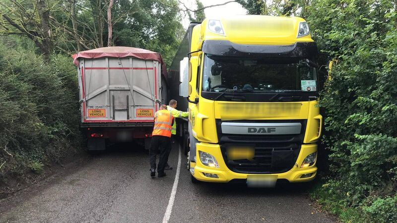 Epic Fail: Articulated trucks close road after getting stuck Epic Fail: Articulated trucks close road after getting stuck