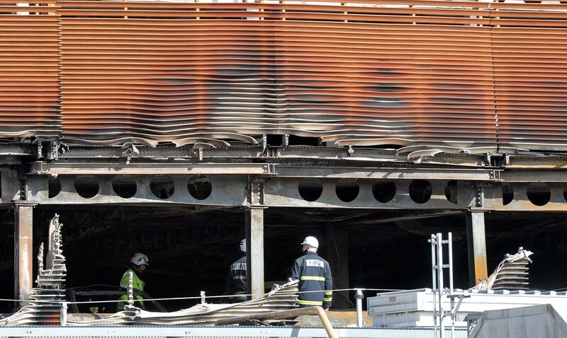 Firefighters inspecting the scene on Sunday morning following a fire in Douglas Village Shopping Centre car park, Cork, on Saturday evening.Picture Denis Minihane. Firefighters inspecting the scene on Sunday morning following a fire in Douglas Village Shopping Centre car park, Cork, on Saturday evening.Picture Denis Minihane.