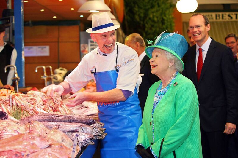 Queen Elizabeth II meeting fishmonger Pat O'Connell at The English Market in Cork City on her State Visit to Ireland. Photo credit: Maxwells/PA Wire