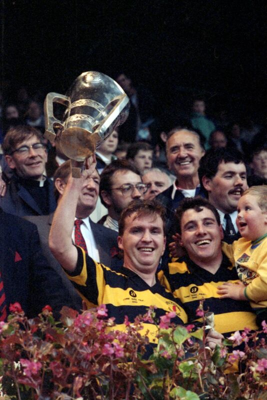 Tony O'Sullivan holding the cup with Jim Hanifin on the right. Tony O'Sullivan holding the cup with Jim Hanifin on the right.