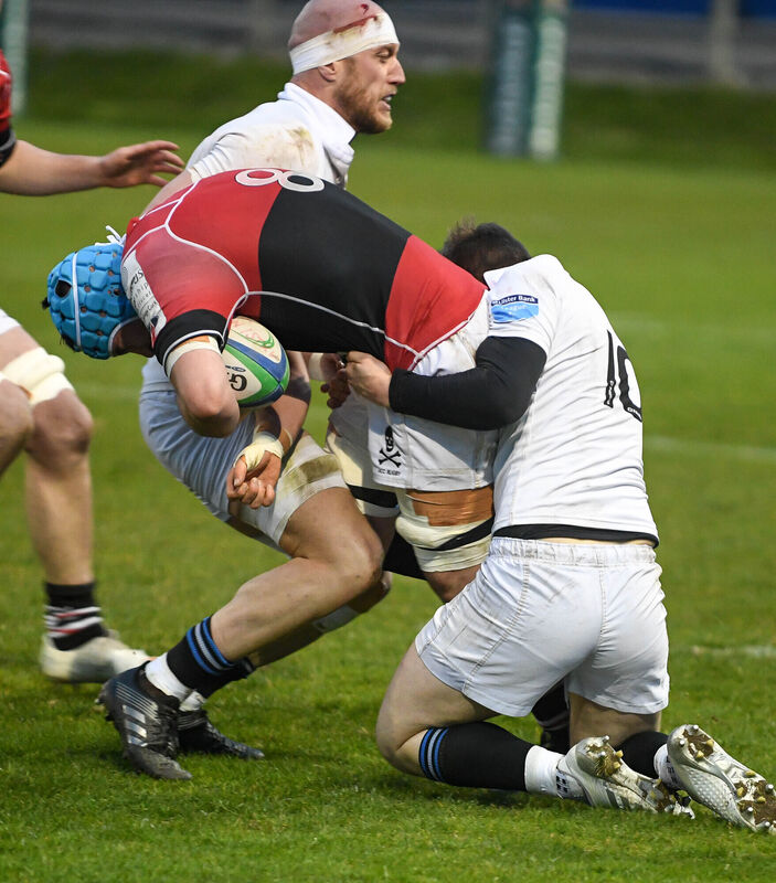 UCC's John Hodnett battles Cork Constitution's Luke Cahill and Aidan Moynihan. Picture: David Keane.