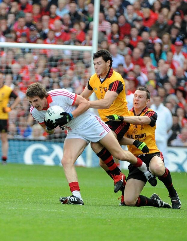 Aidan Walsh gets away from Down's John Clarke and Martin Clarke. Picture: Brian Lougheed Aidan Walsh gets away from Down's John Clarke and Martin Clarke. Picture: Brian Lougheed