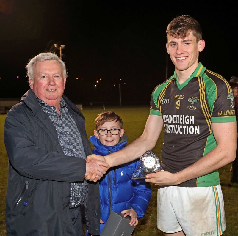Paddy Fitzgerald and Cillian Fitzgerald, present the Man of the Match Trophy to Jack Ryan. Picture: Jim Coughlan.