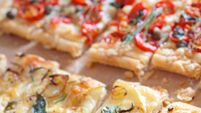 Slices of savory tarts lined up on a table