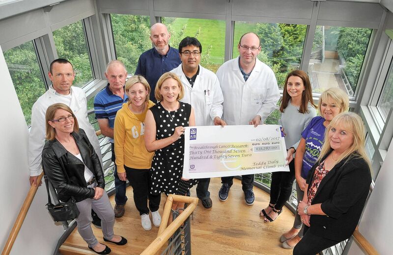 The Teddy Daly Memorial Climb team, family and friends presenting last years fundraising cheque to Dr. Pat Forde and team at the Breakthrough Cancer Research Labs, UCC.