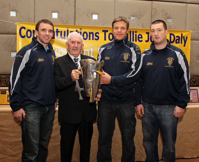 Willie John Daly with the Seán Óg Murphy Cup in 2011 and Carrigtwohill hurlers Brian Lordan, Niall McCarthy and Michael Fitzgerald. Picture: Jim Coughlan.