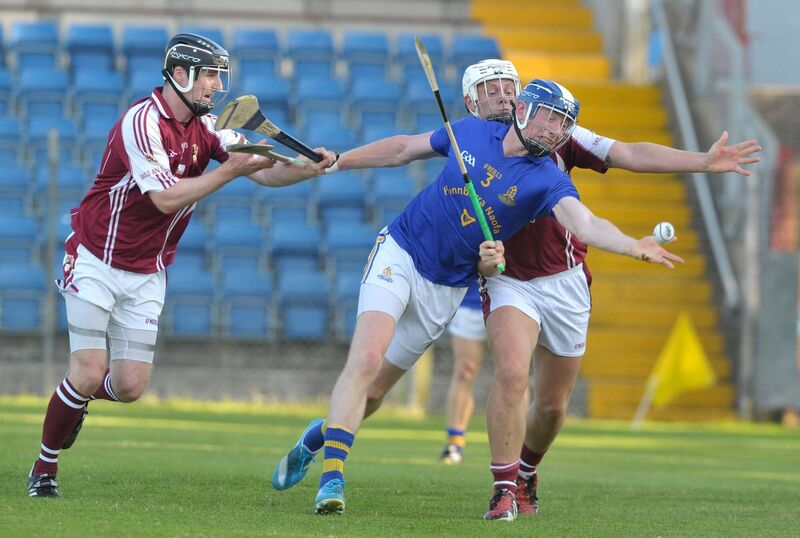 St Finbarr’s Damien Cahalane hand-passing out of defence against Bishopstown forwards Thomas Murray and David Hickey. Picture: Des Barry