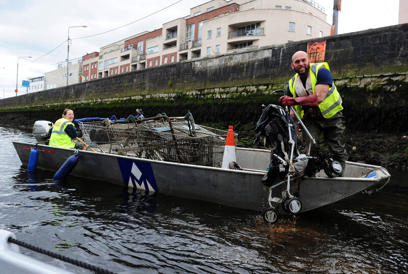 Clare Hayden and Mohammed Namoun of   Meitheal Mara collecting shopping trolleys and a pram dumped in the River Lee. Picture: Eddie O'Hare